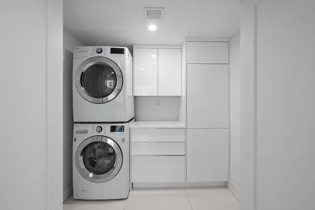 a utility room with sink dryer and washer