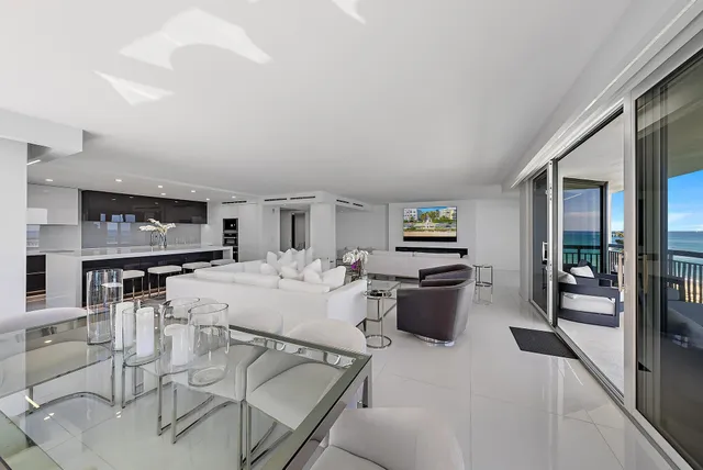 a living room with furniture a flat screen tv and a table