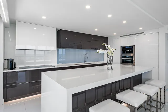 a kitchen with a sink cabinets and wooden floor