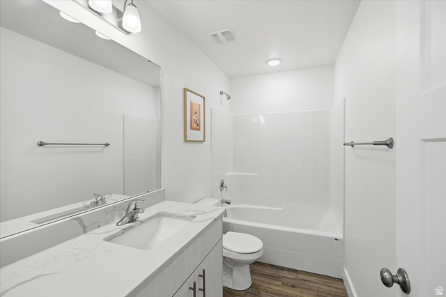 1422 West 3410th Street South Logan, UT 84321 - Photo 20 of 33 Bathroom featuring a white vanity with an integrated sink, a light-toned countertop, and wood-finish flooring