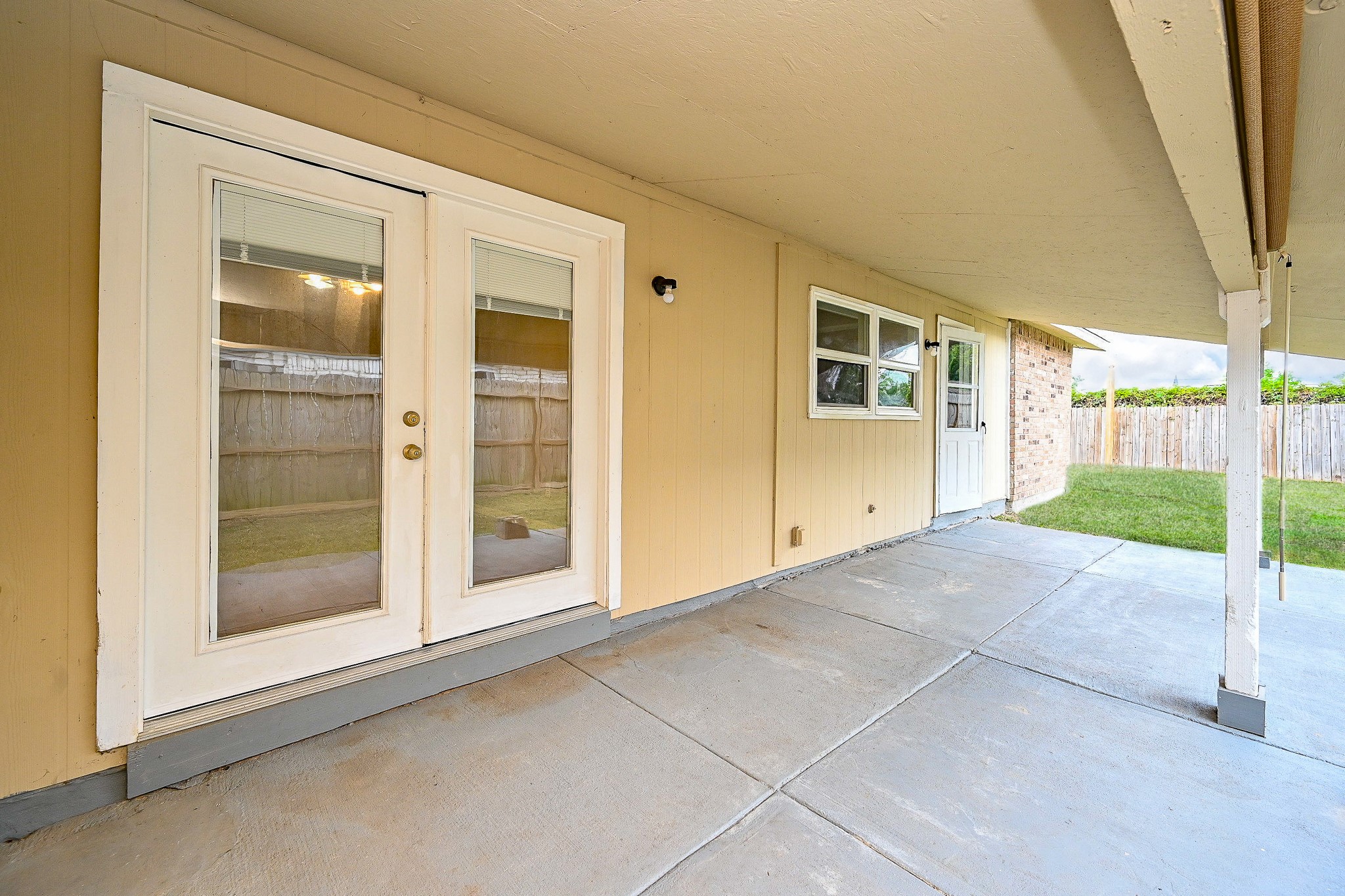 18318 Navajo Trail Drive Spring, TX 77388 - Photo 16 of 16 Covered back patio with concrete flooring and space for outdoor seating. Fenced backyard with room for outdoor entertaining or play.