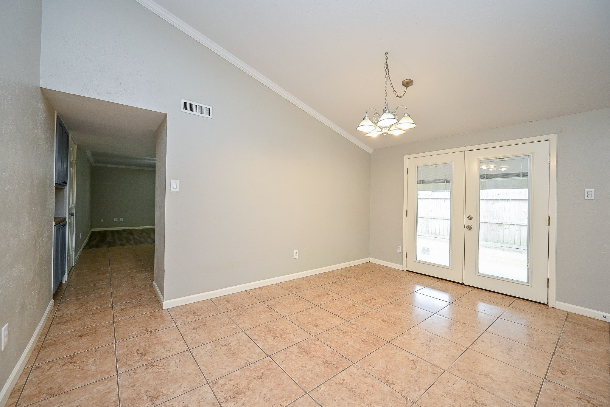 18318 Navajo Trail Drive Spring, TX 77388 - Photo 4 of 16 Dining area with tile flooring, chandelier lighting, and French doors leading to the backyard.