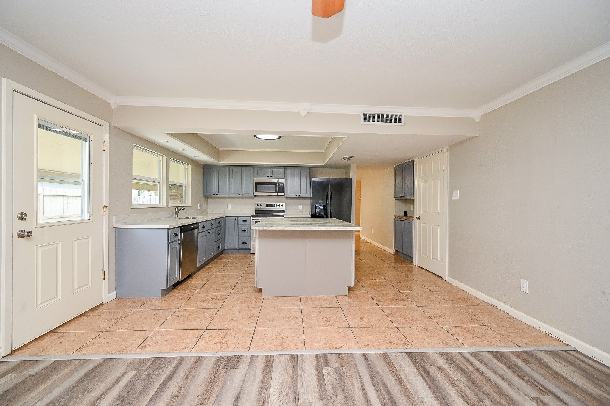 18318 Navajo Trail Drive Spring, TX 77388 - Photo 7 of 16 Kitchen opens to den, featuring a functional layout with island seating and backyard views.
