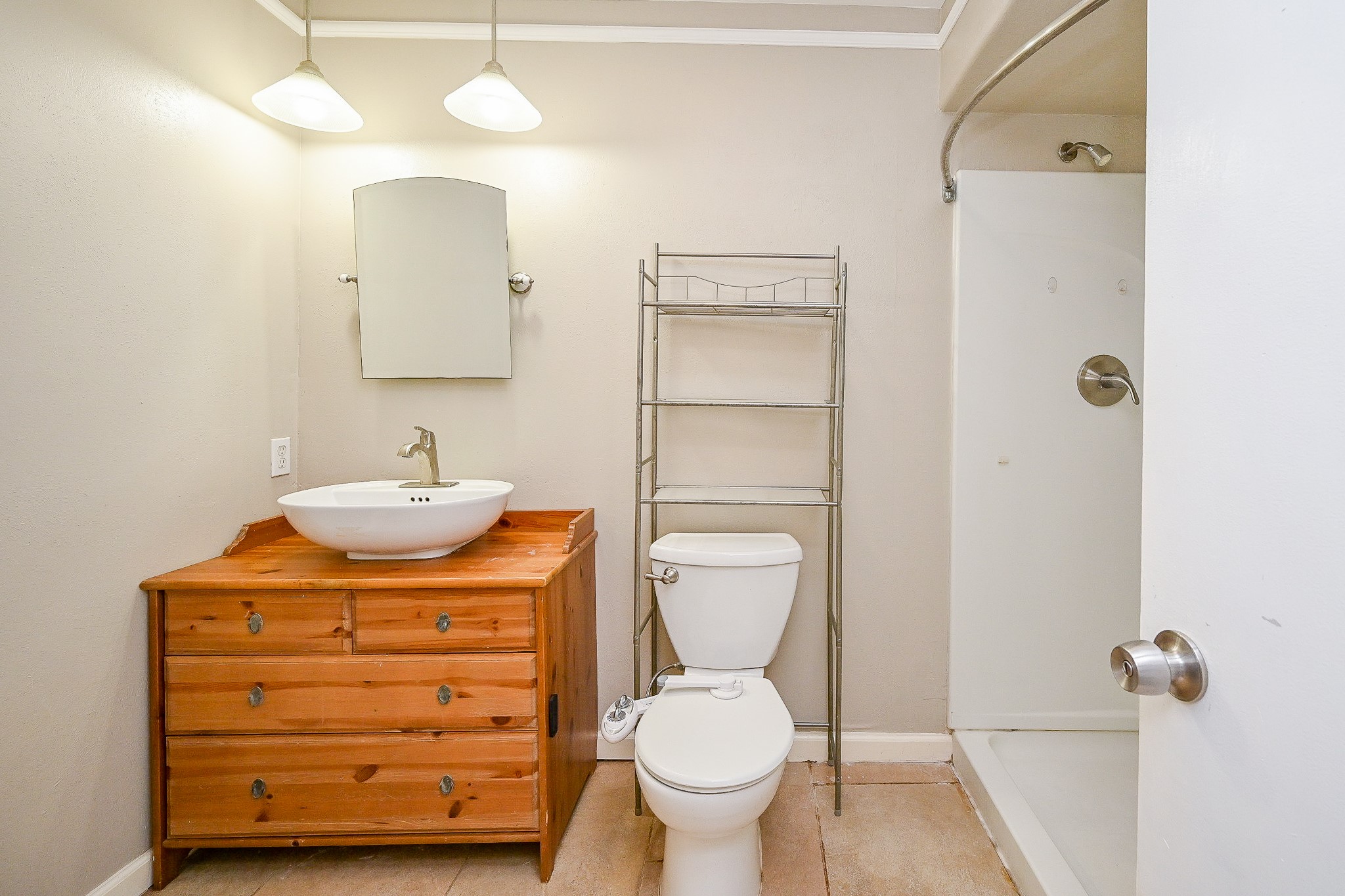 18318 Navajo Trail Drive Spring, TX 77388 - Photo 10 of 16 Primary bathroom with walk-in shower, single vanity, and updated lighting.