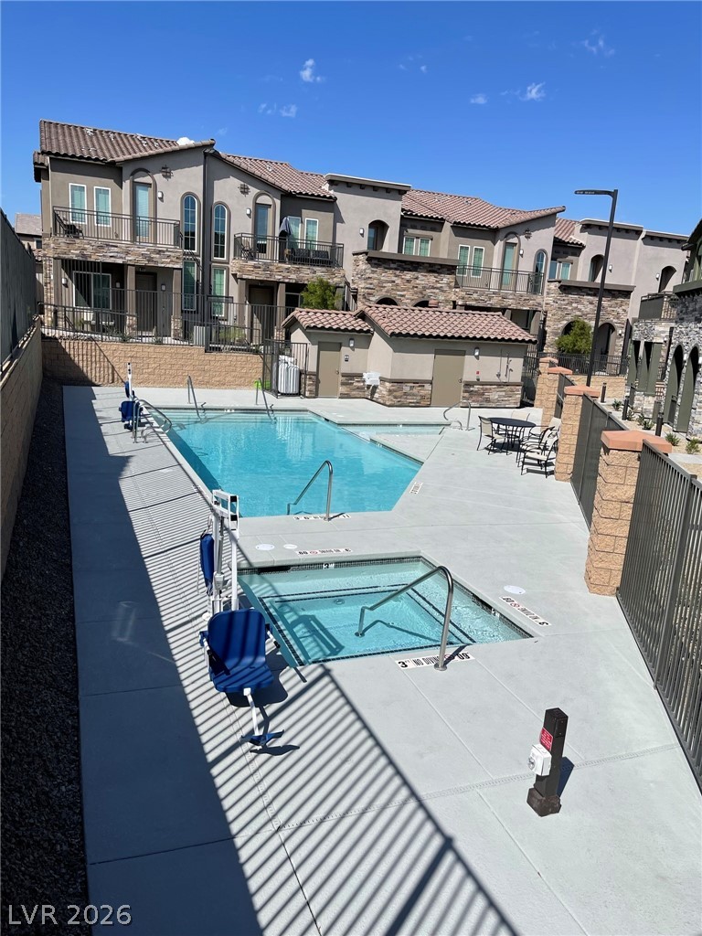 6444 Spring Jog Street Las Vegas, NV 89166 - Photo 11 of 13 This community pool and spa area offers an inviting space for leisure and relaxation.