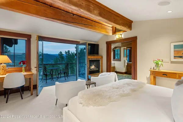 a bedroom with furniture and a large window