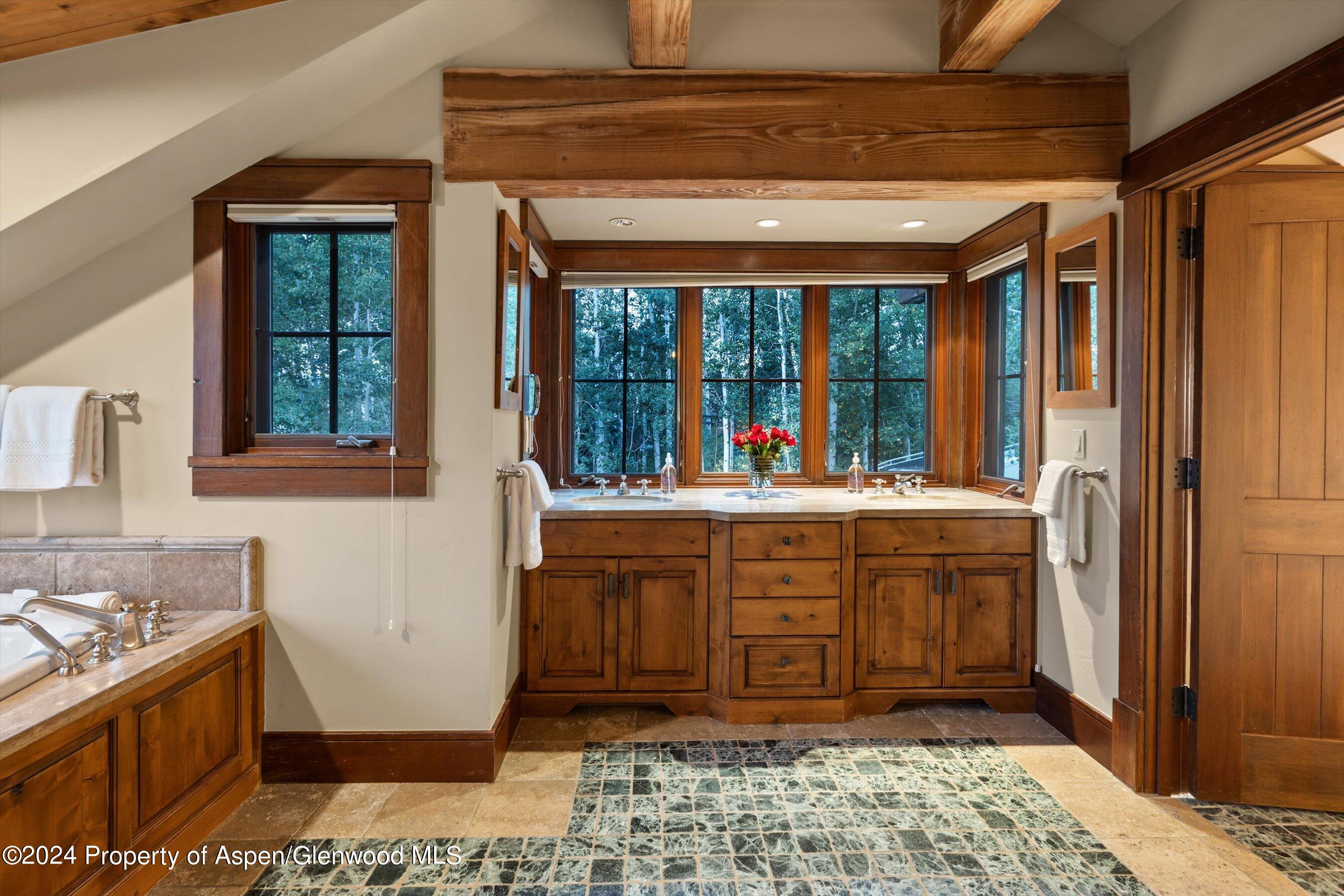 1021 Two Creeks Drive Snowmass Village, CO 81615 - Photo 19 of 47 a bathroom with a tub sink and mirror