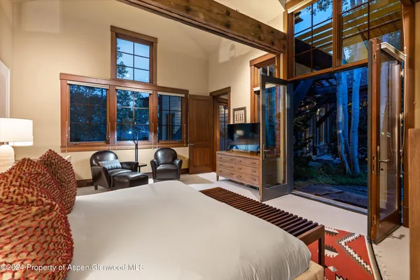 a bed room with a bed and a large mirror