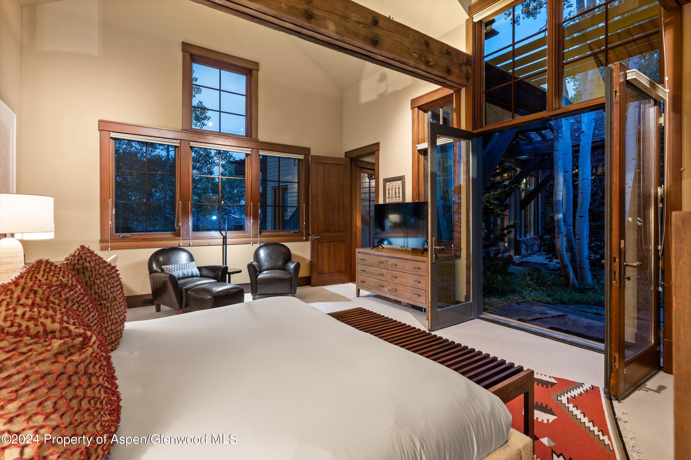 1021 Two Creeks Drive Snowmass Village, CO 81615 - Photo 21 of 47 a bed room with a bed and a large mirror