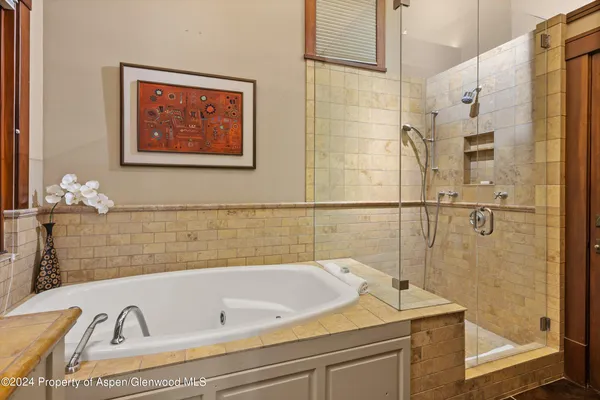 a bathroom with a bathtub and shower