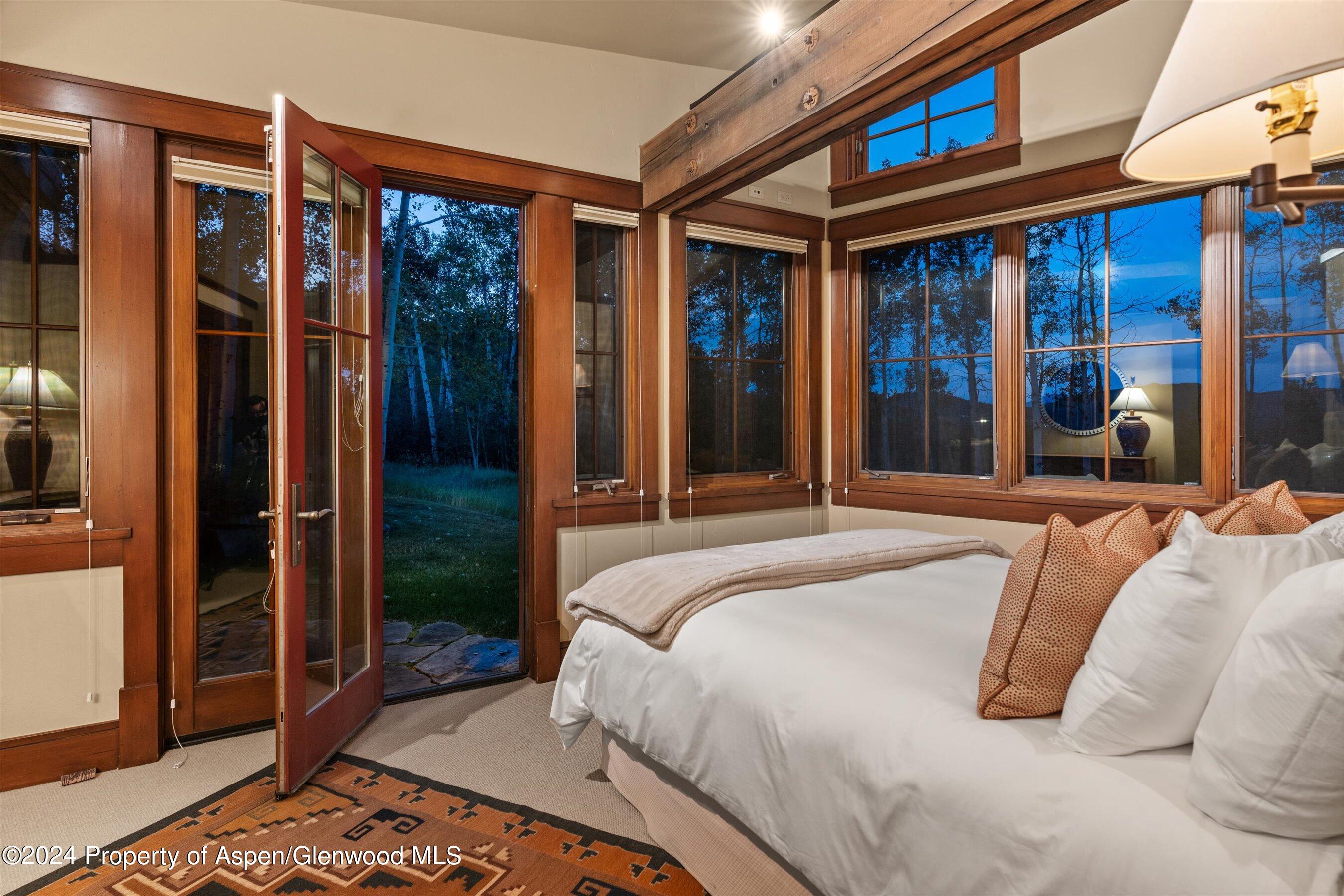 1021 Two Creeks Drive Snowmass Village, CO 81615 - Photo 27 of 47 a bedroom with a bed and glass door