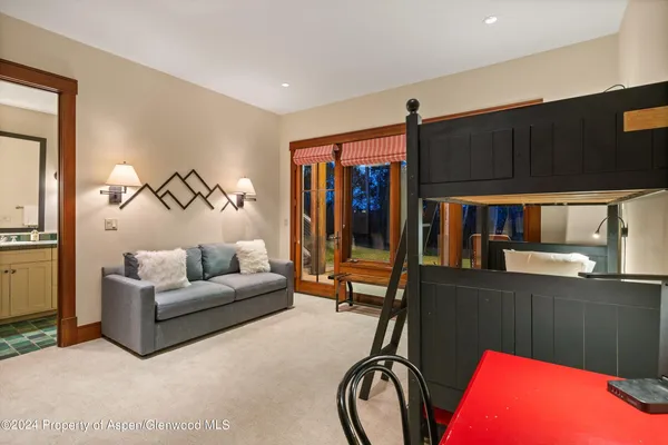 a living room with furniture a air conditioner and a window