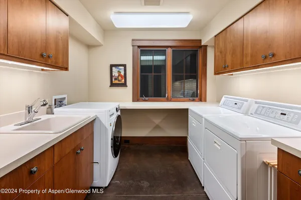 a utility room with a sink washer and dryer