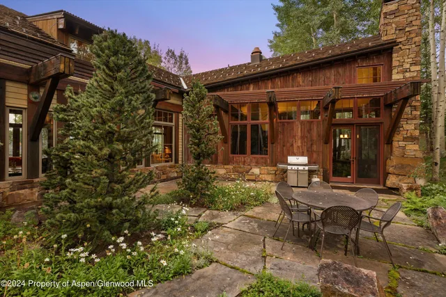 a view of a house with backyard and sitting area