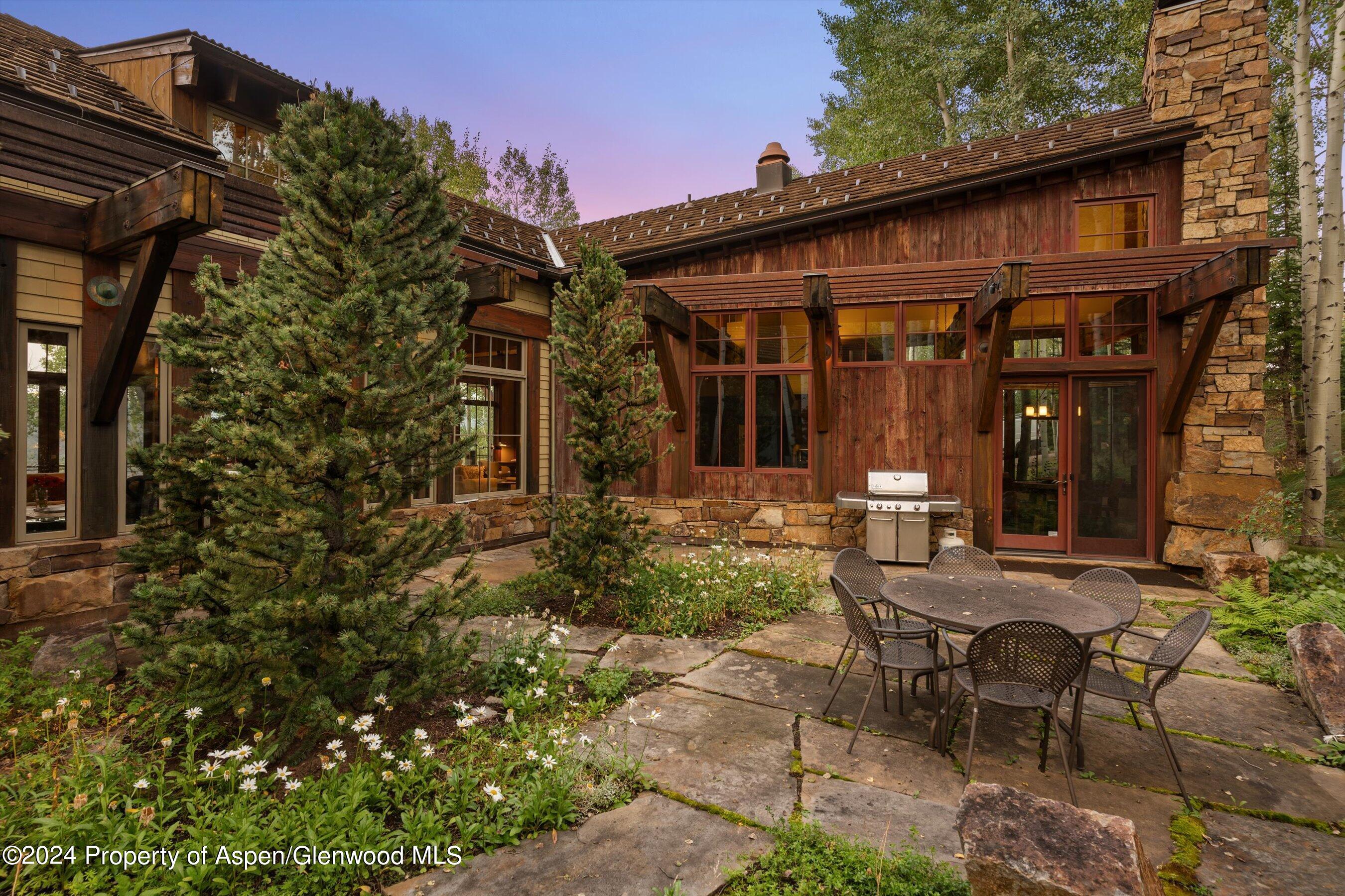 1021 Two Creeks Drive Snowmass Village, CO 81615 - Photo 43 of 47 a view of a house with backyard and sitting area