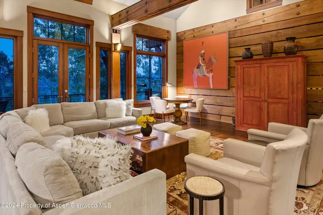 a living room with furniture and large window