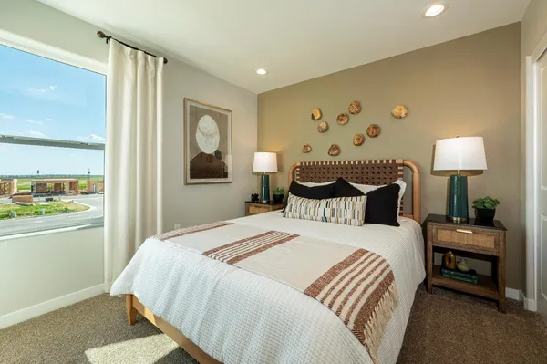 a bedroom with a bed and a lamp with table