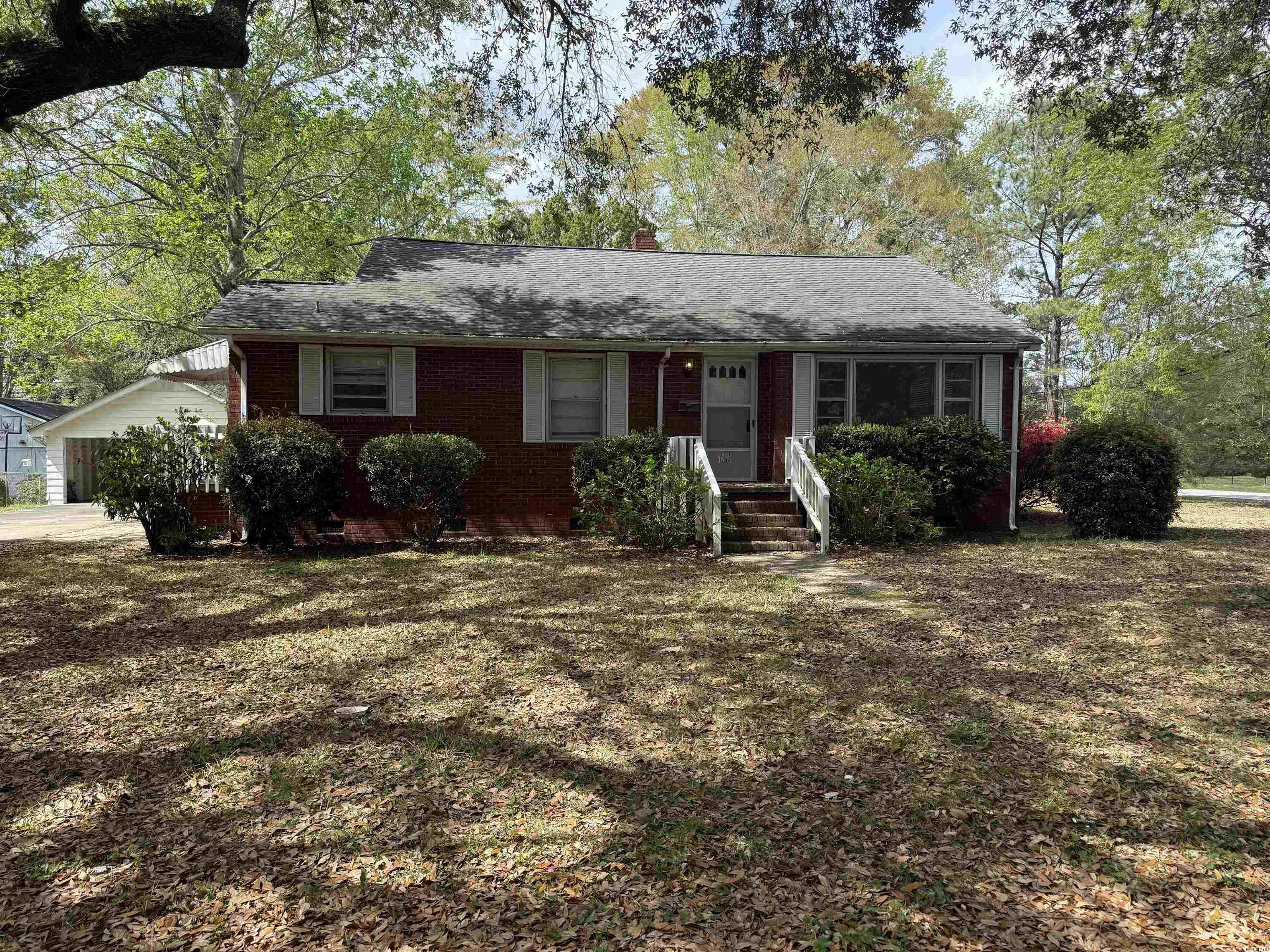Ranch-style house featuring brick siding