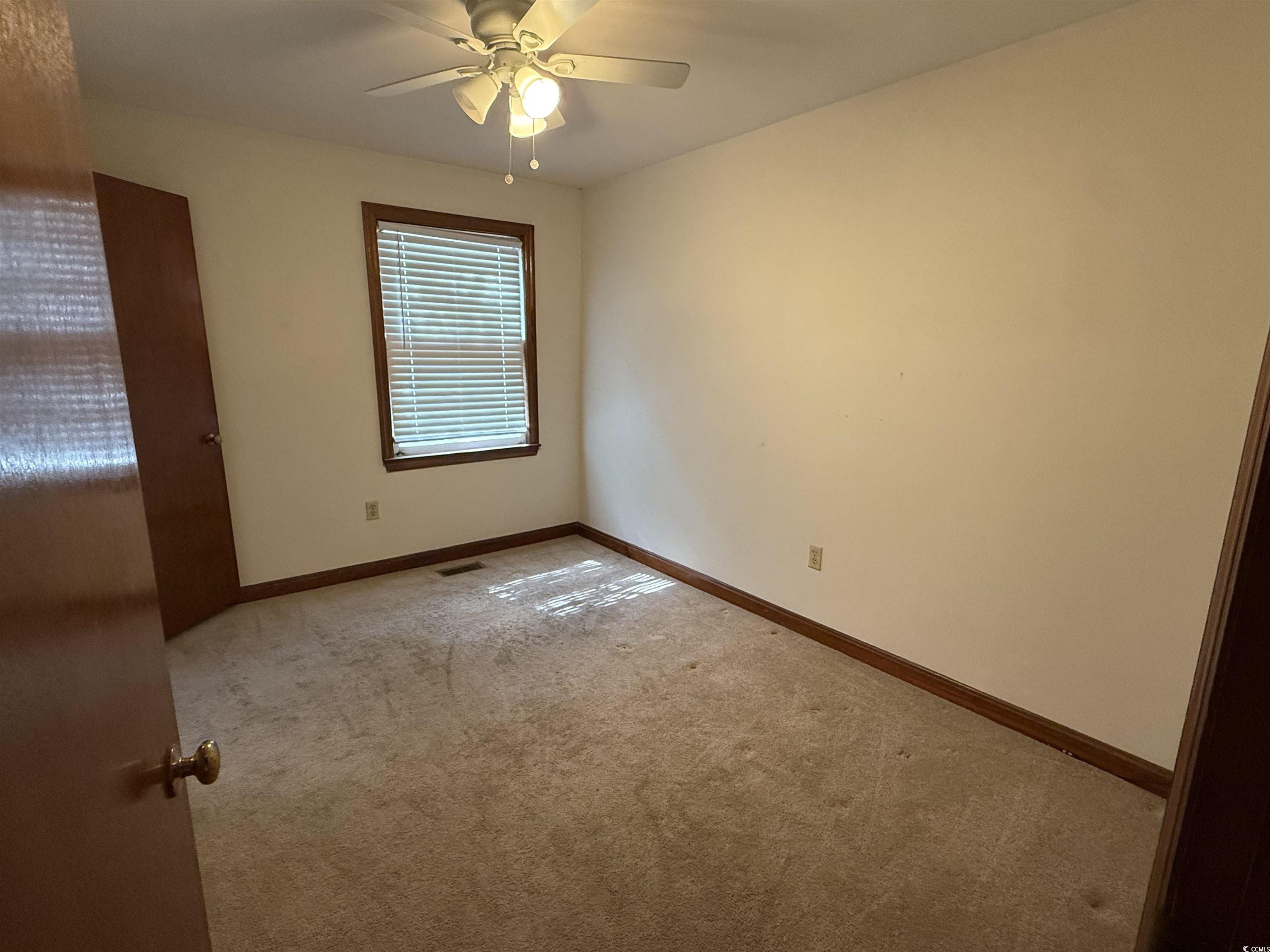 1208 Richmond Drive Georgetown, SC 29440 - Photo 9 of 9 Carpeted spare room featuring baseboards, ceiling