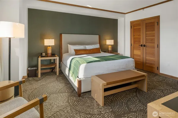 a bedroom with a bed and a flat screen tv in it