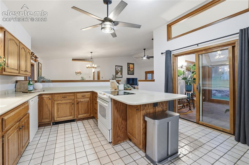 18190 Forest View Road Monument, CO 80132 - Photo 15 of 50 a kitchen with a sink stove and cabinets