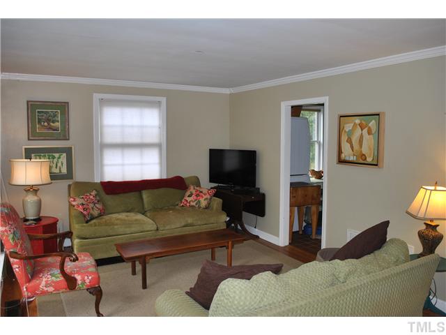 710 New Raleigh, NC 27608 - Photo 5 of 25 a living room with furniture and a flat screen tv