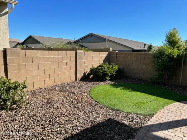 a view of a house with a small yard and plants