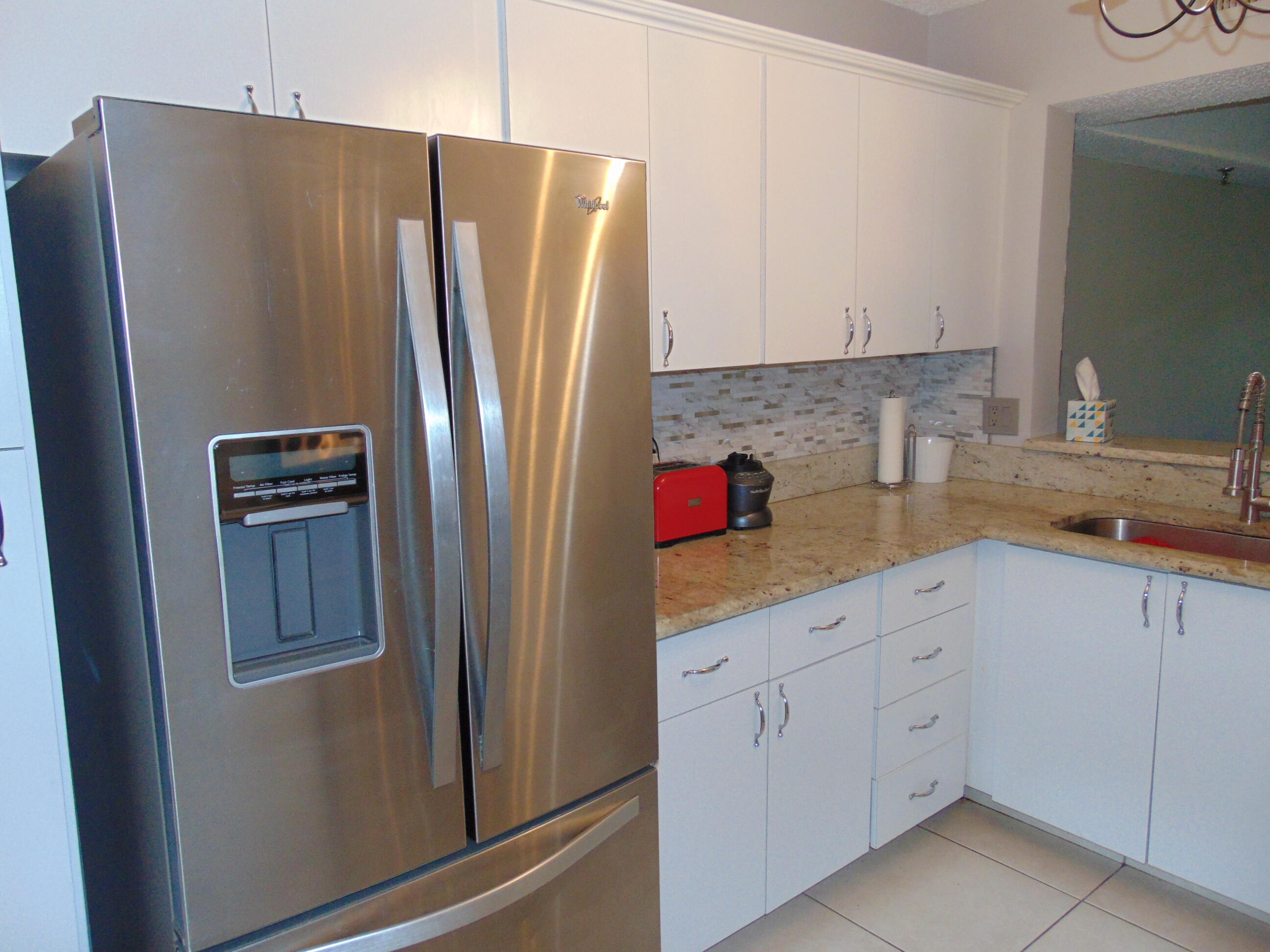 9220 Southwest 14th Street, Unit 3103 Boca Raton, FL 33428 - Photo 2 of 58 a kitchen with appliances and cabinets