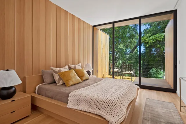 a bedroom with a bed and a large window