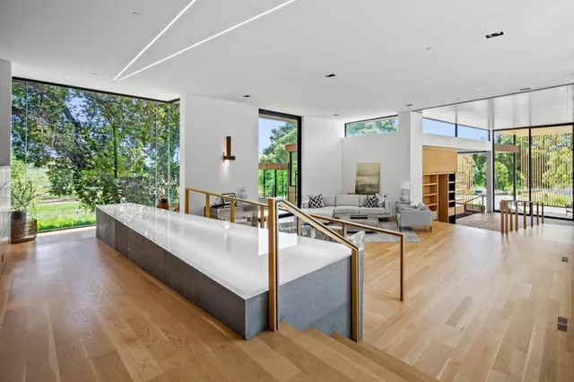 a living room with large window and a wooden floor