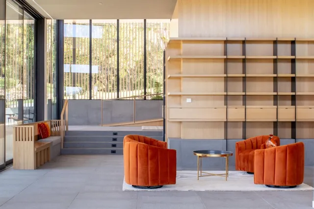 a dining room with furniture and a floor to ceiling window