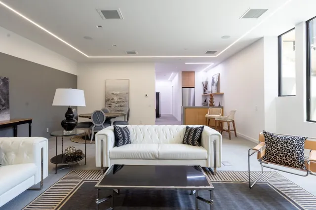 a porch with a table and chairs next to a yard