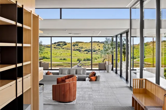 a living room with furniture and a floor to ceiling window