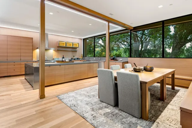 a view of a living room and kitchen with furniture wooden floor and a fireplace