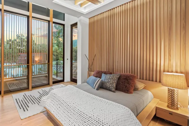 a bedroom with a large bed and a large window