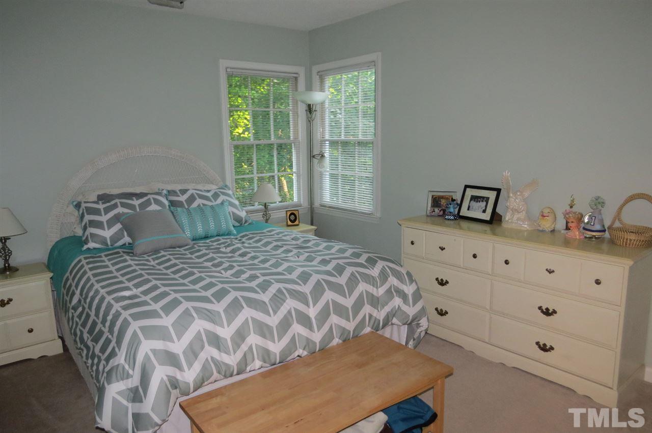 5417 Ingate Way Raleigh, NC 27613 - Photo 11 of 16 a bedroom with a bed and window