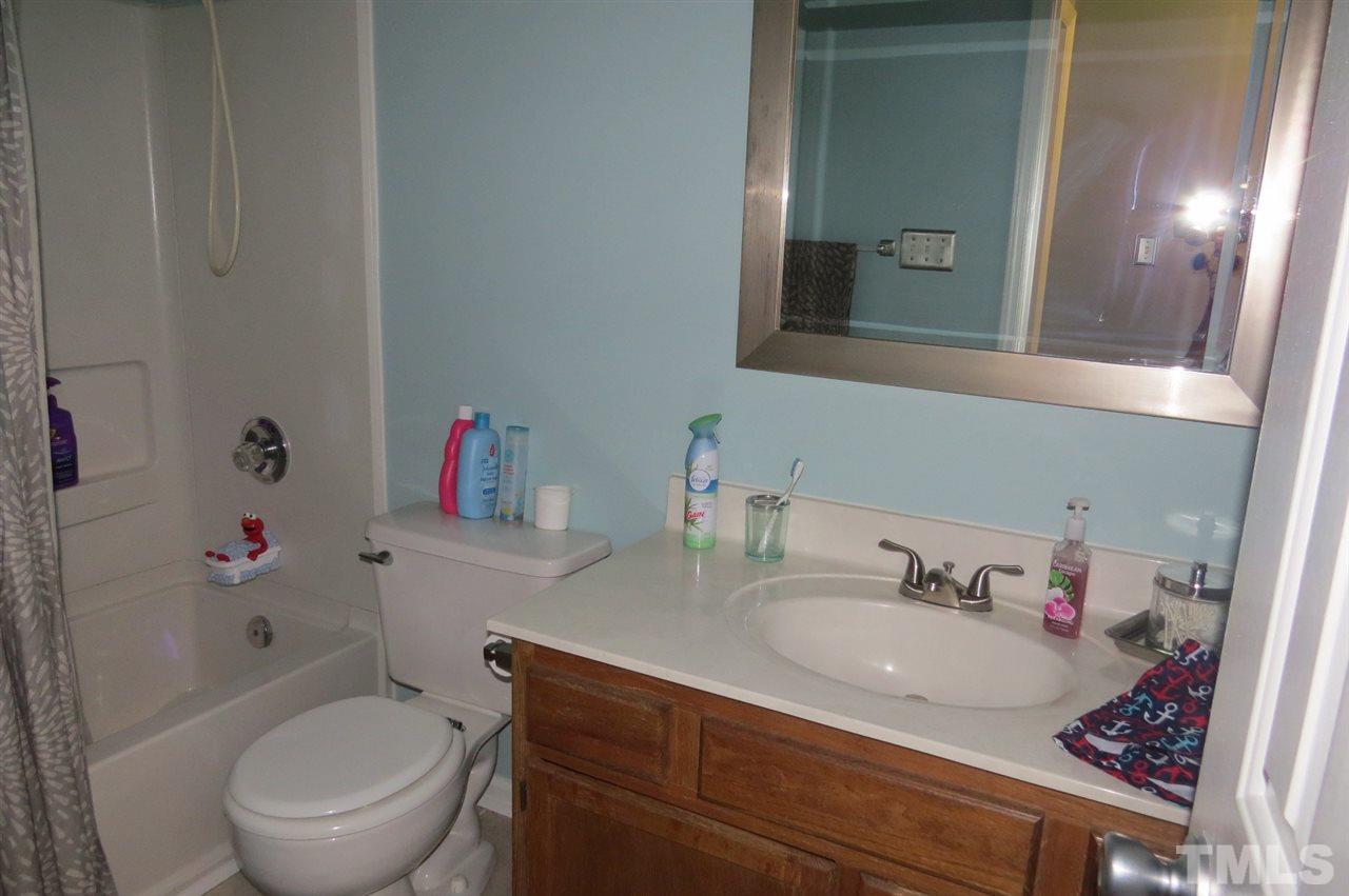 5417 Ingate Way Raleigh, NC 27613 - Photo 12 of 16 a bathroom with a sink toilet vanity and tub