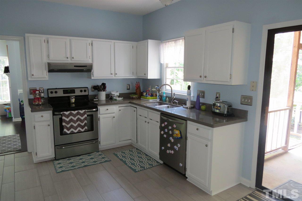 5417 Ingate Way Raleigh, NC 27613 - Photo 3 of 16 a kitchen with granite countertop a sink cabinets and window