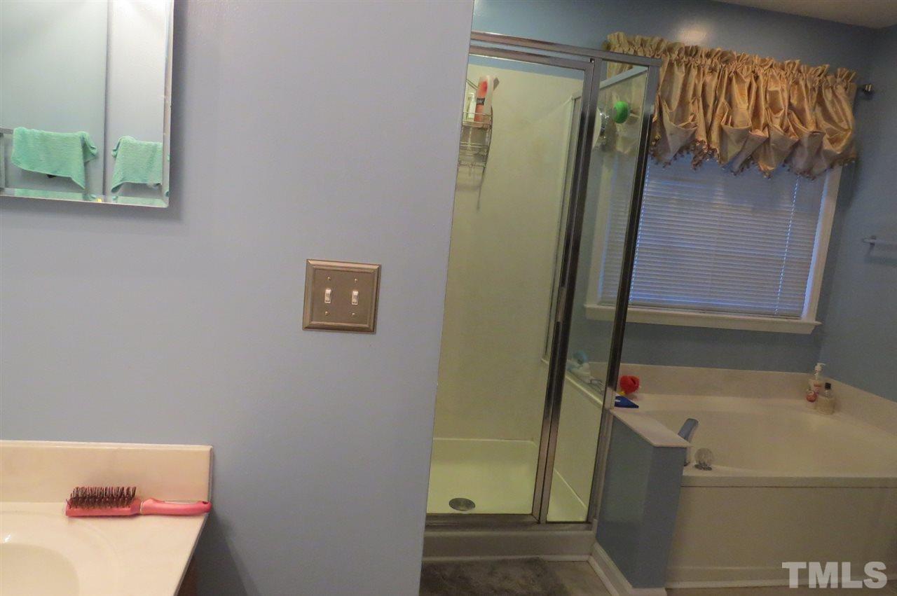5417 Ingate Way Raleigh, NC 27613 - Photo 9 of 16 a bathroom with a bathtub and shower