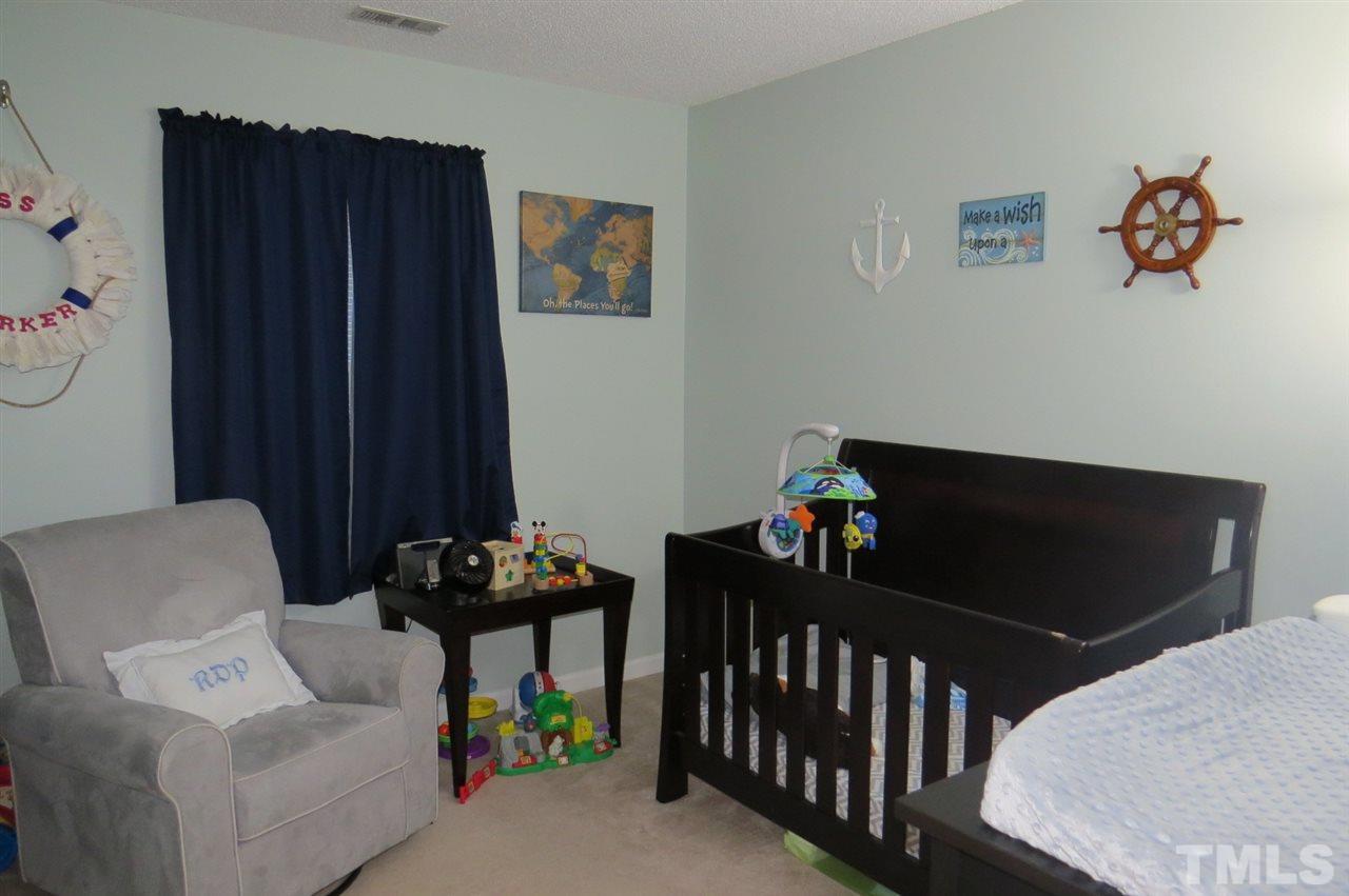 5417 Ingate Way Raleigh, NC 27613 - Photo 10 of 16 a bedroom with furniture and a window