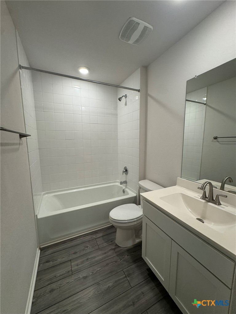 208 Ida Loop Seguin, TX 78155 - Photo 8 of 16 a bathroom with a double vanity sink toilet mirror and bathtub