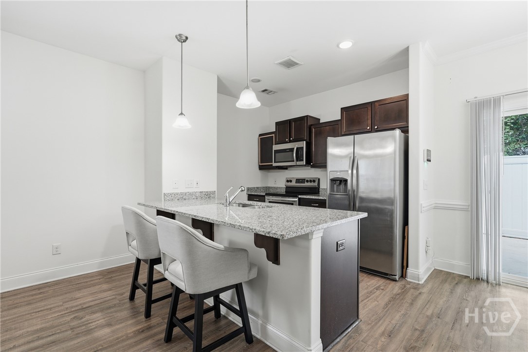 11330 White Bluff Road, Unit 31 Savannah, GA 31419 - Photo 11 of 36 Kitchen features granite countertops and tall cabinetry.