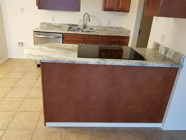 a view of cabinets with stainless steel appliances wooden floor