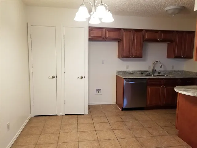 a kitchen with a sink a counter space and cabinets