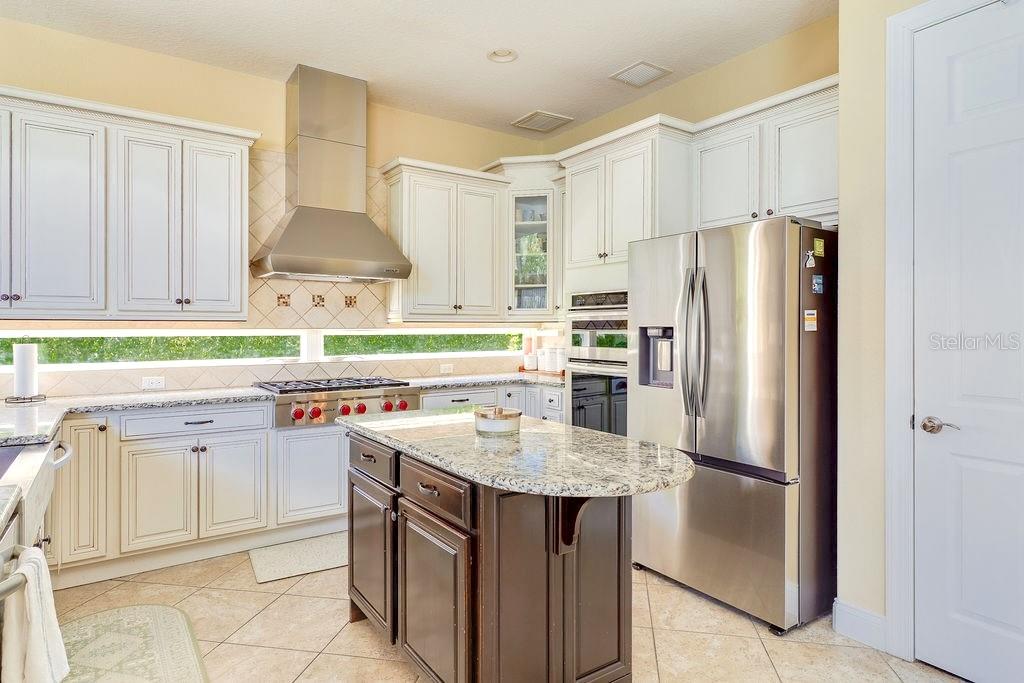 13448 Bellaria Circle Windermere, FL 34786 - Photo 11 of 66 a kitchen with stainless steel appliances a sink stove and refrigerator