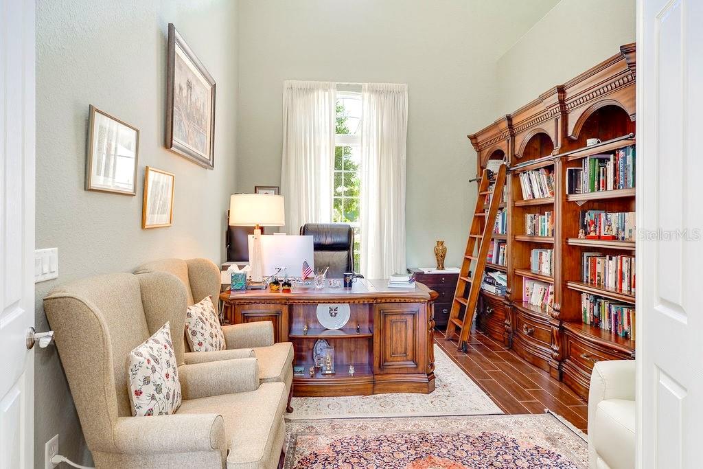 13448 Bellaria Circle Windermere, FL 34786 - Photo 16 of 66 a living room with furniture book shelf and a window