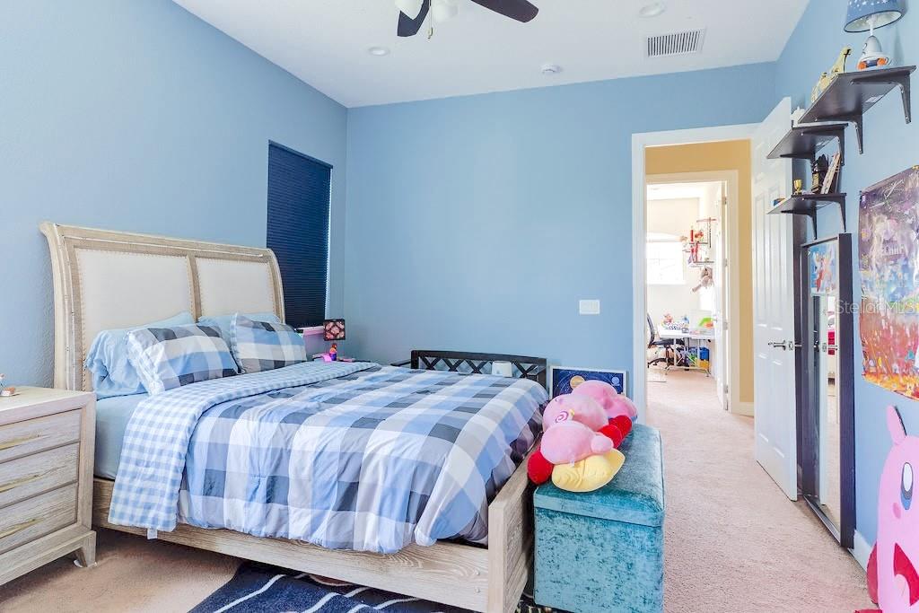 13448 Bellaria Circle Windermere, FL 34786 - Photo 33 of 66 a bedroom with a bed and wooden floor