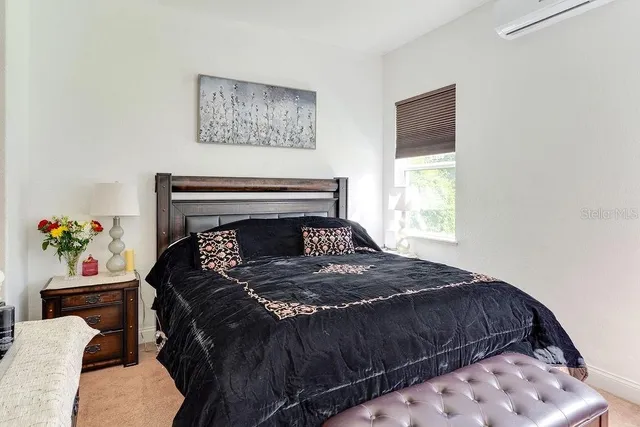 an aerial view of residential house with outdoor space and trees all around