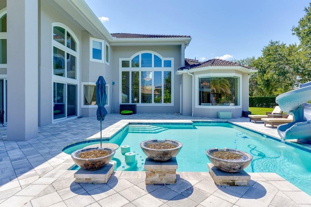 13448 Bellaria Circle Windermere, FL 34786 - Photo 43 of 65 a view of a house with backyard sitting area and swimming pool