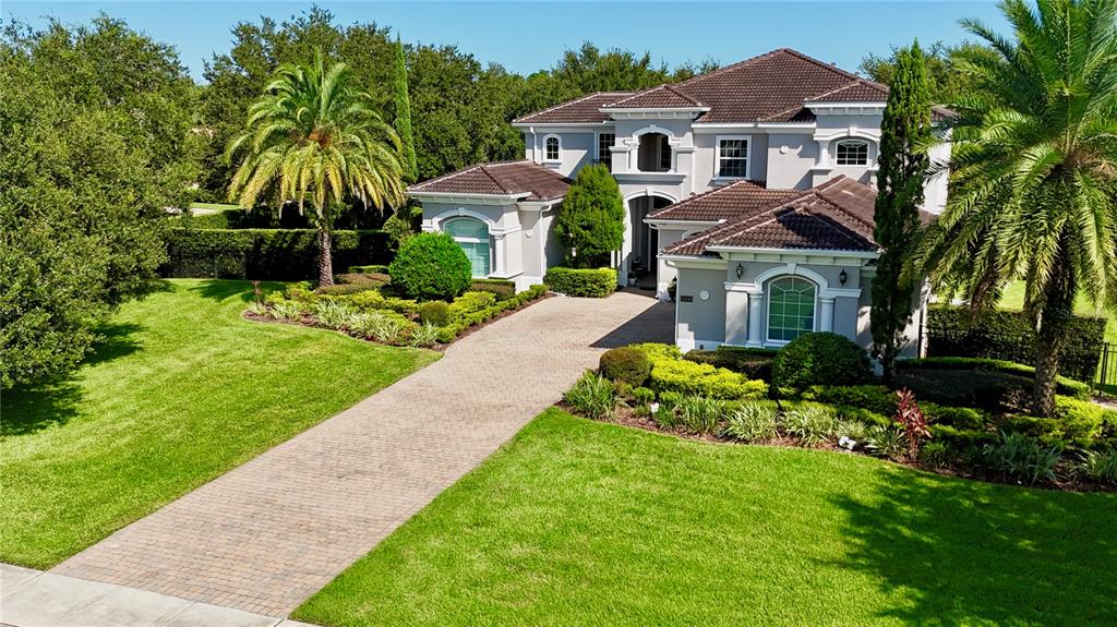 13448 Bellaria Circle Windermere, FL 34786 - Photo 55 of 66 a front view of a house with a garden